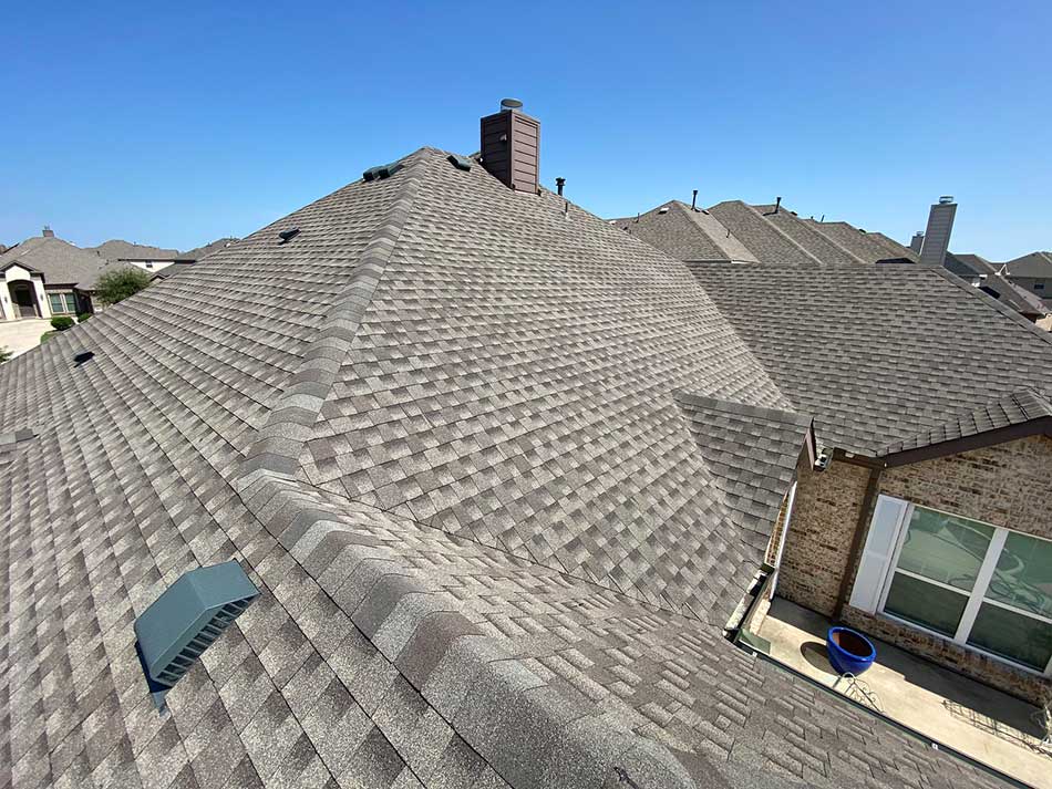 Aerial view of brown residential roof installed by J Riley Roofing